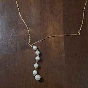 Dangling bead necklace, gold chain.